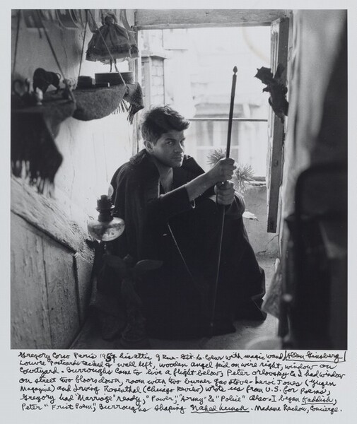 Gregory Corso Paris 1957 his attic 9 Rue-Gît-Le-Coeur with magic wand, Louvre postcards tacked to wall left, wooden angel kid on wire right, window on courtyard. Burroughs came to live a flight below, Peter Orlovsky & I had window on street two floors down, room with two burner gas stove – LeRoi Jones (Yugen magazine) and Irving Rosenthal (Chicago Review) wrote us from U.S. for poems, Gregory had “Marriage” ready, “Power,” “Army” & “Police” also. I began Kaddish, Peter “Frist Poem,” Burroughs shaping Naked Lunch. Madame Rachou, Concierge.