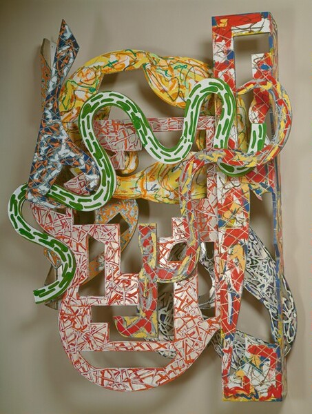 Snake-like and geometric shapes covered with energetic patterns of vivid red, yellow, green, blue, and orange are layered to form this abstract, roughly oval sculpture, which hangs on a wall. The shapes have oval, rectangular, L-shaped, and square openings cut into them, and their patterns are created with scribbles, squiggles, dashes, and blobs of color like canary yellow, tomato red, lime green, cobalt blue, and white. The frontmost layer has undulating curves in kelly green on white. Other layers have red and yellow marks against gray, red and silver against white, and blue and silver. A tall rectangle on the right side extends slightly above and below the oval form of the rest of the sculpture.
