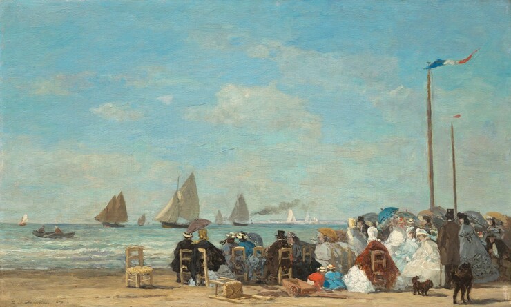 About two dozen men and women sit in straight-backed, wooden chairs gathered along a sandy beach near low, gently breaking waves with sailboats floating in the ocean beyond in this horizontal landscape painting. The scene is loosely painted throughout, making much of the detail indistinct. Most of the people sit with their backs to us but the faces we can see suggest they all have light skin. The people gather in a loose crowd that crosses the right two-thirds of the composition. The women wear long dresses with full skirts, their shoulders wrapped in matching shawls in black, smoke gray, royal or arctic blue, rust-red, or cream white. Some wear straw-colored hats with black or baby blue bands and others wear scarves over their hair. The men also wear hats, most of them black top hats, and suits in black or pecan brown. Some people hold up parasols in harvest gold, slate blue, teal, or gray. A few straight-backed, wooden chairs with rushed seats sit empty or tipped over to our left of the group. Two children, one wearing marigold orange and the other topaz blue, and both wearing straw hats, kneel or squat and bend over the sand at the back center of the group. Two dark brown or black dogs, one small and one large, stand behind the group, to our right. Two tall, wooden poles rise high above the crowd near the right edge of the composition. A thin banner with blue, white, and red stripes flutters from the pole closer to us, and a red banner lifts in the breeze in the one farther away. Painted with thick, visible brushstrokes, low waves lined with ivory white crests lap against the shore in bands of pale lilac purple, light turquoise, and aquamarine blue just beyond the crowd. Two people sit in a rowboat in the ocean to our left and several sailboats with oatmeal-tan sails move into the distance to the horizon, which comes about a quarter of the way up the composition. Bright white strokes to our right could be sails in bright sunlight, deep in the distance. One boat amid the sailboats puffs a plume of gray smoke. Pale, almost translucent white clouds drift across a pale azure-blue sky above. The artist signed and dated the painting in the lower left corner: “E. Boudin 63.”