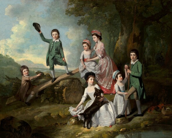 Three young boys, four girls, and a dark brown dog gather in a loose semi-circle in a grassy clearing near a grove of trees in this horizontal landscape painting. The children all have pale, white skin, brown hair, and dark eyes. The girls wear corseted dresses with long skirts and caps, and the boys wear jackets with tails, knee-length pants, stockings, and black shoes with buckles. The three boys look at us while the four girls look around the scene. A long plank of wood has been laid across a thick, sawed tree trunk to make a seesaw. One boy, wearing fawn brown, sits on one end near the ground, to our left. The oldest girl braces the youngest on the opposite end of the plank, which is lifted into the air. The oldest girl wears a sheer, white apron over a coral-pink dress. Like the other two girls, the youngest child wears a white dress but hers has a coral-pink sash and the same color ribbons are tied into her and the oldest girl’s white caps. A boy wearing a moss-green suit looks at us and raises his dark cap in one hand as he stands balanced with his feet widely planted at the center of the angled plank of wood. To our right and closer to us, one of the younger girls, wearing a robin’s egg blue sash with a blue ribbon in her cap, stands in front of the oldest boy, who holds a tall staff that reaches off the top edge of the painting in the crook of one elbow. This boy holds a small, silver fish in both hands. The girl touches one of his hands with her own, and looks up at the fish. The fourth girl and the dog sit on the ground at the front center of the painting. The dog rests its front legs across her lap and she looks off to our right. A pool of water reflects light in the lower right corner of the painting, and a deeply shadowed, verdant forest frames the rightmost third of the composition. Upon closer inspection, we find an open basket and red cloth near the water, almost lost in shadow near the lower right corner of the painting. Beyond the group of children. a tree-filled valley leads back to another body of water and hills in the deep distance to our left, and a few pale gray clouds float across a blue sky.
