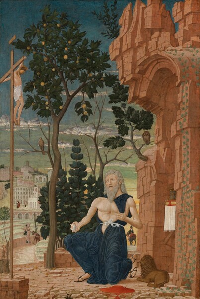 In front of a crumbling stone building, an old man kneels in front of a second man, smaller in scale, hanging from a tall, wooden cross, with a city in the background in this vertical painting. Both men have pale skin. At the lower center of the composition, the kneeling man, Saint Jerome, pulls his navy-blue robe to one side to expose his muscular but slender bare chest with a bloody mark at its center. With his other hand, he holds a rounded, gray stone touched with pink, also suggesting blood, by his side. The man has long, silvery-gray hair and a long, pointed beard. His coral-pink lips are parted and his teeth show. He raises gray eyes to look up at the man on the slender cross, which rises along the left edge of the composition. That man has chestnut-brown hair, a plate-like gold halo, and a white loincloth is draped across his hips. The shell-pink ground is littered with rocks. A crimson-red hat with a shallow brim and a tasseled chin cord sits near Saint Jerome’s sandaled feet. A miniature caramel-brown lion lies between Saint Jerome and the arched opening of the crumbling, terracotta-red structure along the right edge of the painting. Ivy grows up one side of the arch, and an hourglass and book with a scarlet-red cover and gold-edged pages sit on a white cloth under the opening. An owl perches on a branch of an oak tree growing from the front face of the structure, and a hawk sits on a branch of the fruit tree growing from the stone courtyard, between Saint Jerome and the crucifix. A shrub with dark green leaves and clusters of three olive-green fruits fills in most of the space beneath the canopy of the fruit tree. To our right and in the distance, a man with a pointed black hat, a black jacket, and white pants rides away from us on a gray horse. To our left, the courtyard gives way to an amphitheater-like space. There, next to a donkey, a man with a long white beard hands a bundle of wood or planks to another man whose brown hair is cut into a ring encircling his head. Both men wear rose-pink garments over navy-blue togas. A town with white and pale pink stone buildings rises up a hill into the distance. The sky above deepens from honeydew-green along the horizon to pale then peacock blue along the top edge of the composition. A few ice-blue, white, and light gray clouds float across the sky.