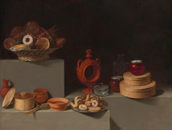 A basket of fruit, a plate of baked goods, glass jars, round wooden boxes, and terracotta-red and orange vessels are arranged among gray stone ledges set at different heights span the width of this horizontal still life painting. Light falls across the objects from the left, and the background is deeply shadowed, nearly black. Near the top left corner, a woven basket sits on the tallest ledge, almost reaching the top of the composition. It contains dark, plum-purple fruits, a golden loaf of bread in a white wrapper, and several translucent, glistening pieces of fruit in shades of brown and gold. Several long, garnet-red, finger-like objects are tucked among the fruit, and a braided white ring is propped in front. A ledge below this one starts in the lower left corner and spans just over half the width of the composition. Three terracotta vessels, a round, wooden box with its lid propped on its side, and a pewter-silver dish loaded with figs and baked sweets are arranged along the plinth, seeming close to us. Two long, fawn-brown, finger-like objects, perhaps more pastries, are tucked between the wooden box and a terracotta bowl. On the pewter dish, some of the pastries are round like doughnuts and sprinkled with white sugar, some curve in S-shapes, and at least one is long and straight. The third ledge extends from the center of the composition off the right edge, and it is situated behind the pewter dish and alongside the ledge with the basket. To the left on that ledge and at the center of the composition, a tall, rust-red vessel has a hollow center, creating a ring with a flaring foot. It has handles on the shoulders near the tall neck and spout. Shell shapes adorn the perimeter of the hollow center. A glass bowl filled with clear liquid and a round, glass jar filled with a red food, perhaps preserves, sit nearby. The jar sits in front of a translucent glass carafe, which is also tucked behind a stack of two round, lidded boxes, the one on top smaller than the one beneath. Another jar filled with cherry-red fruit sits atop the smaller box. The jars are sealed with twists of paper. The artist signed and dated the work as if he had inscribed the front face of the ledge near the lower right, “Juan vanderHamen i Leon fat 1627.”