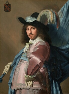 Seen from the hips up, a man with pale skin and shoulder-length brown hair wears a long-sleeved, lace-trimmed, rose-pink satin jacket and pants and props a voluminous blue flag draped from a pole against his right shoulder in this vertical portrait. He stands with his body facing our left in profile with his left hand on his hip, elbow jutting out at us, but he turns his face to look directly at us with dark eyes. He has a straight nose, rosy cheeks, and a mustache and narrow goatee below his lips, which are slightly parted. He wears a wide-brimmed black hat generously adorned with pale blue, turquoise, pale yellow, and orange plumes. The fabric of his pink clothing reflects the light in wide patches of white, creating the impression of a satin sheen. Wide, pale gray lace lines the front opening of the jacket, the shoulders, the arms, and the sides of the trousers. His white lace collar is tied with a pale celery green bow and a bow of the same color appears to affix the lace cuff of the wrist we can see. A baby blue sash wraps around his waist and is probably tied at the back, but the area behind his body is lost in shadow because the man is lit from our left. Both hands are covered with ivory colored gloves. His left wrist rests against his body so the underside of those fingers dangle down while the other hand supports the blue fabric-covered flag pole. A sword hangs from his front hip. The fabric of the flag, or standard, drapes down from the flag pole, which extends off the top right corner of the canvas. A coat of arms, about the size of a person’s palm, hangs from a nail with a string in the upper left corner on the taupe-colored wall behind the man. The coat of arms is made up of three fleur-de-lis lined up in a diagonal band and the remaining two corners are filled with stylized lions, long tongues curling out. The artist dated the work “1640” in the lower left corner.