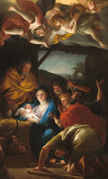 Four men, a boy, an ox, and a donkey crowd around a young woman holding a baby inside a shadowy wooden structure in this vertical painting. Five angels, all with blond curly hair and two with wings, float in a bank of gray clouds above. The men below have tanned skin while the boy, woman, baby, and angels have pale skin with rosy cheeks. All of their faces are illuminated by the bright light emanating from the baby, Jesus, who lies cradled in the woman’s arms. That woman, Mary, sits to our left of center next to the manger, a wooden structure like a crate, overflowing with straw, on which she rests Jesus. An azure-blue mantle covers her blond hair and wraps around her pale lavender robe. Her body is angled to our left but her head turns toward us as she looks over our heads with hazel eyes. Touches of white paint on her lower lids suggest tears about to spill over. She has a delicate nose, a rounded chin, and her small pink mouth is closed. Jesus is swaddled in a white cloth and smiles slightly as he gazes up and off to our left. An older man, Joseph, leans into the scene from the shadows to Mary’s right, our left. He has a curly gray beard and hair, and wrinkles furrow his brow and line his cheeks. His lips are parted, and he looks down with dark eyes. His butterscotch-yellow cloak is wrapped tightly around his body. The heads of the donkey and ox look toward the light from below Joseph, next to the manger. The other three men and young boy gather to our right. The men wear pine-green, black, scarlet-red, or pale yellow garments, and two of them are bearded. They bow, kneel, and gesture toward Jesus. The one closest to us bows his head low on his hands and knees, a staff next to him on the ground. We see his cleanshaven, lowered face through his wide-spread arms. The young boy stands smiling next to Mary with his hands raised as if he were about to clap. These men and the boy are framed by an open doorway beyond them, which opens onto a dimly lit landscape with palm trees and hills under a pale blue and white sky. Above, the two angels closest to us have moss-green wings. They wear robes in sage green, rose pink, and golden yellow. Some look down with hands in prayer or arms crossed over their chest. The two at the back of the group, in the upper right corner of the painting, look up and off the composition as one points downward.