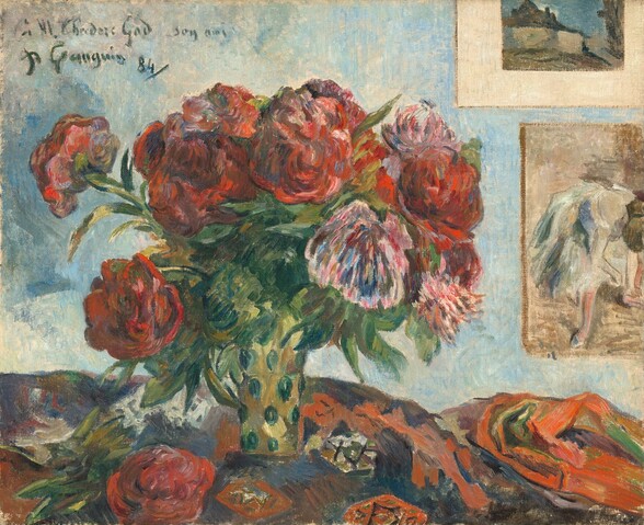 About a dozen ruby-red and bright pink peonies in a gold and green vase sit on a rumpled cloth in this loosely painted, horizontal still life. The flowers, cloth, and background are painted with visible brushstrokes, making many of the details indistinct. Nestled among moss-green leaves, most of the flowers are red but three pink peonies are interspersed in the bouquet, to our right. One additional red peony lies on the table, near the lower left corner of the painting. The narrow vase holding the flowers has emerald-green ovals against a celery-green background. The fabric bunched on the table is loosely painted in strokes of pumpkin orange, indigo blue, and asparagus green, that together suggest a geometric pattern. The wall behind the bouquet is streaked with sky blue and parchment white, and two pictures hanging one over the other, to our right, are cut off by the top and right edges of the composition. The top picture has a wide, cream-white mat and shows a tan house with a charcoal-gray roof against a blue sky. The bottom picture shows a ballerina wearing a knee-length tutu bent forward over her knees, presumably tying a slipper. The artist inscribed, dated, and signed the work in pine-green paint in the upper left corner, “à M. Théodore Gad son ami” and, underneath, “P Gauguin 84.”