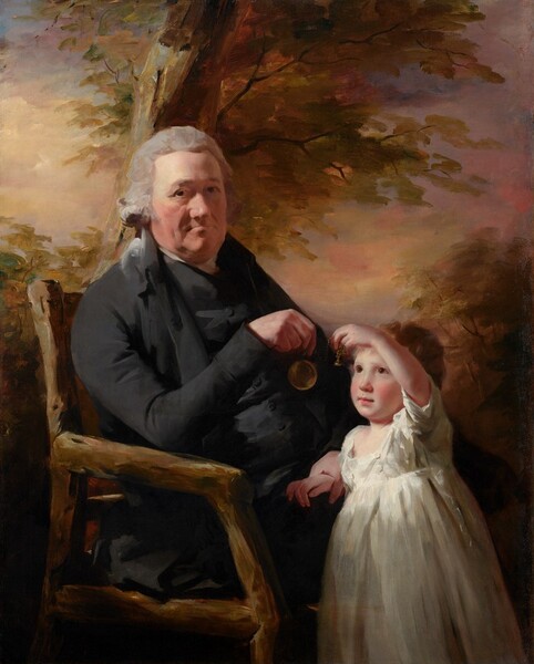 Shown from the knees up, an older man sits in a rustic wooden chair and holds up a pocket watch for a young child who stands at his knees in this vertical portrait painting. They both have pale, peachy skin with flushed cheeks. They are lit from our upper left so the man’s face is partly in shadow while light pours onto the child’s upturned face. The man’s body is angled to our right, almost in profile, but he turns his head to look at us with dark eyes under heavy brows. His has a bulbous nose, lined cheeks, and a heavy jowl around thin lips, which are closed in a line. His light gray, wavy hair is tied back at the nape of his neck. He wears a black coat with a high collar and tightly fitting sleeves. A streak of white at his neck suggests a white shirt under the black, high-necked vest that covers his torso. He rests his right elbow, closer to us, on the arm of the chair so he can dangle a pocket watch in front of the child. The man’s knees disappear behind the child, who leans against his legs. The pocket watch is attached to a short gold chain, and the child holds up the fob, which is shaped like a Hershey’s Kiss candy, at the end of the chain. The young boy looks up at the watch with luminous, brown eyes. He has smooth, round cheeks, a short nose, and his pink lips are closed. The child has wavy, golden brown hair and his white garment has a squared neckline, short sleeves, and falls like a skirt off the bottom edge of the painting. The background behind the pair is painted with streaks of marigold orange, gold, and olive green to suggest trees against a sky painted with butter and harvest yellow, rust orange, and just a touch of pale blue at the upper left corner. The entire portrait is loosely painted, especially in the background, chair, and clothing.