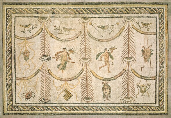 Created with tiny pieces of colored marble, stone, and glass, this rectangular mosaic shows four columns separated by stylized peacock feathers. Each vertical zone is divided again by two curving, garland-like swags into three sections, which are filled with birds, people, masks, or other objects, and is framed with a twisted, rope-like pattern around the edge. The entire mosaic is created with matte tones of light beige, chocolate brown, pale yellow, olive green, black, and white. In each column, a bird on a branch occupies the top section. Below, and separated by the garlands, the center sections each have a single object, with masks in the form of bearded men’s faces hanging from ribbons in the columns to our left and right. A nearly nude woman covered loosely with drapery holds a long spear and what might be a tray of leafy food in the second column from the left, and a nude man holding a curving staff and perhaps another tray or foodstuffs strides to our right in the second column from the right. Drapery flutters around each person’s shoulders. In the bottom row, there is an object like a stylized eye to our left; an L-shaped object, perhaps a stylized, broken column, in the space next to it; a mask with long hair and downturned lips in the next space; and, finally, an urn holding fruit. All four objects in the bottom row are suspended with thin cords. The background throughout is oyster white. The border is made up of butter-yellow, brick-red, and olive-green S-shapes with black and white bands, entwined to make a twisted pattern.