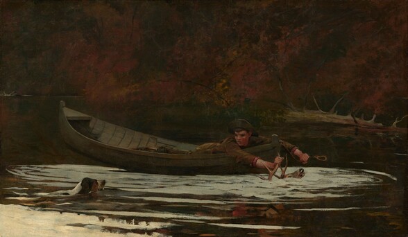 A young man with a peachy, ruddy complexion lies on his stomach in a wooden rowboat on a river, reaching forward to grasp the horn of a stag almost completely submerged in the rippling water with one hand. On the opposite riverbank, gold, rust, and scarlet-red trees span the width of this horizontal painting. The boy’s arms straddle the stern of the boat so one holds the antler with his right hand, closer to us, while the other clutches a rope with a loop at the end. He turns his face, mouth agape and cheeks flushed, over his right shoulder to look to our left, at a dog swimming toward the boat. The dog has white and caramel-brown markings, with dark brown ears. The boy wears earth-brown clothing and the front of his wide-brimmed hat is pushed up to reveal dark eyes and sable-brown bangs and brows. The stag and dog are between us and the boat, and are surrounded by thick brushstrokes of parchment white to create ripples in the forest-green water. Only the open muzzle, part of the eye, and the tips of the stag’s antlers are above the water’s surface. To our right, a bare, fallen tree lies along the far riverbank parallel to the boat. The boat and water fill the lower half of the scene and the autumn trees fill the upper half. The artist has signed and dated the painting in the lower right, “Winslow Homer 1892.”