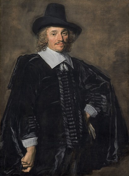 Shown from the thighs up, a man with pale, peachy skin, wearing a black suit, cape, and hat, stands with one hand on his hip against an elephant-gray background in this vertical portrait painting. The portrait is loosely painted in some areas, especially in the clothing and background, though the face is more detailed. His body is angled slightly to our right so one shoulder juts toward us, to our left, and he turns his face to look at us brown eyes. One bushy brow is slightly arched. He has a long, bumped nose, soft jowls along his jawline, and perhaps a mole almost lost in shadow on his left cheek, to our right. His wide, pale peach lips are closed and framed by a thin, brushy mustache and a patch of hair under his lower lip. His shoulder-length, wavy, light brown hair curls around his face, and he wears a tall, black hat with a wide brim turned over his right ear, to our left. A hip-length black cloak drapes over a long-sleeved black jacket. A wide, flat, white collar lies across his shoulders and is tied with fluffy tassels that hang on his chest. Streaks of slate-gray suggest horizontal bands next to buttons down the front of his jacket and along the forearms, above white cuffs. He stands with his right arm, to our left, hanging by his side, and he holds the fabric of his cloak in a loose fist. The back of his other hand rests against his left hip, to our right, and a few streaks of parchment brown suggest a glove in that hand. The background is painted with thin, blended areas of gray and peanut brown.