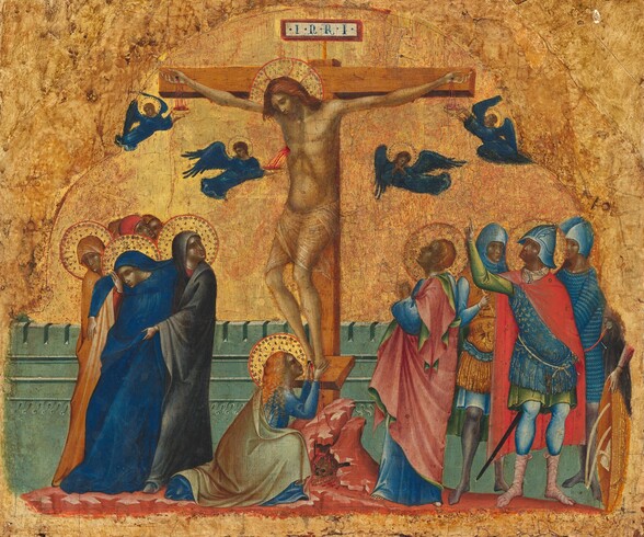 At least eleven people gather around a man hanging from a wooden cross, all against a gold background in this nearly square painting. The people have pale skin tinged heavily with gray, and pink on the cheeks. At the center of the composition, the man, Jesus, hangs from nails driven into the cross through his palms and feet. His thin body is covered only by a sheer loincloth across his hips. His knees angle to our left, and his head tips in that direction. He has a beard and auburn-brown, shoulder-length hair. His eyes are closed under furrowed brows. A gold halo surrounds his head and has red lines radiating to the red outline of the disk. The letters “INRI” appear on a panel on top of the cross. Three small, winged angels, like miniature people, catch vibrant red blood spurting or trickling from Jesus’s two palms and a gash over his right ribs in gold bowls. A fourth angel clasps hands in prayer. The angels have brown or blond hair, gold halos, and cobalt-blue robes and wings. A woman with long, curly, copper-colored hair kneels at the base of the cross, holding Jesus’s bleeding feet. To our left, a woman wearing lapis-blue swoons into the arms of two women who wear hoods and robes in marigold orange or nickel gray. All four women have gold halos, as do two of the four men standing together to our right. One of those men has short, copper-blond hair and wears a blue robe. His cloak is rose pink on one side and green on the other. He holds his small hands together in prayer and looks up at Jesus in profile. The other three men wear helmets and armored breastplates. One of them, at the front of that trio, has a halo and he points up at Jesus. The hand and torso of another person is visible along the right edge of this group, but the upper body has been lost. The cross sits on a low, rocky rise over a small cavern holding a skull. The ground around the cross and groups is carnation pink. A crenelated, turquoise-colored wall, about elbow height, runs across the back of the scene. The glimmering gold background is worn in some areas, revealing the red ground beneath the gold leaf.