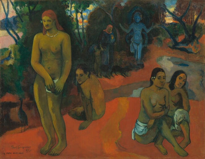 Four young women with medium brown skin sit or stand on a pumpkin-orange ground in this horizontal landscape painting. The women are divided into pairs by a broad, gold, undulating brushstroke running down the middle of the ground they occupy. They are mostly nude, and three have long black hair while one has flame-red hair. To our left, the woman with red hair stands facing us, wearing a glittering, silver necklace as she gazes off to our right. She presses a white patch, perhaps the end of a loincloth, to her upper leg with both hands. Seated next to her is a woman with most of her body turned away from us. She leans over onto her left arm and turns her head over that shoulder to look down and off to our right. Both women to our right are seated close to each other, their shoulders overlapping. One woman wears a white cloth around the hip we can see and the other wears knee-length breeches. They both look toward us. Beyond the women is what appears to be a stream running diagonally from the lower left and ending in a small pool in the middle right. It transitions from muted oranges and green to smoky blues and greys. Opposite us, more orange ground is lined with dense groves of dark green trees that wind into the distance. A woman wearing a coral-colored hood and denim-blue robe holds the arm of a child, and a black dog crouches at their feet. They stand near a slightly larger-than-life-sized topaz-blue statue of a standing woman with her elbows bent and arms raised. The sky beyond the trees is streaked and swirled with bright orange, yellow, and blue. The artist signed and dated the painting, along with the title, in the lower left corner, “Paul Gauguin 98 TE PAPE NAVE NAVE.”