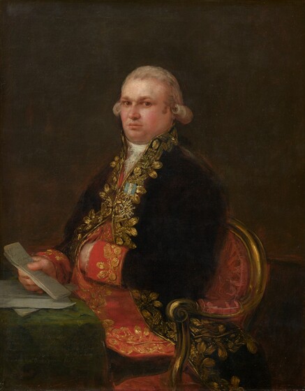 Shown from the hips up, a pale-skinned, heavy-set, elegantly dressed man sits at the corner of a table, looking at us in this vertical portrait painting. Against a dark brown background, the man’s body is angled to our left, and he stares at us from the corners of his brown eyes. His eyebrows are drawn together, and his pink lips are set in a line. His round face is cleanshaven, and he has full, flushed cheeks and a double chin. His gray hair is brushed back off his forehead and curls in a furling row over each ear. His black, high-necked coat is densely decorated with loosely painted gold leaves and patterns around the collar and down the front. A gold, starburst-like medal hangs from a short ribbon striped in white and light blue amid the gold trim. The coat’s wide, scarlet-red cuffs are lined with gold buttons and are also decorated with gold trim. A froth of white lace nestles at his throat. The coat is buttoned over his chest and drapes open across his hips over a red garment, possibly a vest, also edged with gold decoration. The tail of his black coat hangs down under the arm of his chair, which has a curving, gold wood frame and crimson-red upholstery. The man’s left elbow, closer to us, rests on the arm of his chair, and that hand is tucked into the gap between buttons of his red garment. His other hand rests on the pine-green cloth covering the table in the lower left corner of the composition. He holds a folded piece of paper in that hand, which rests on more papers. The folded paper is painted with the words, “El Sor Dn Antonio Noriega Tesorero General F. Goya 1801.” There is more writing on the front of the tablecloth, but it is difficult to make out.