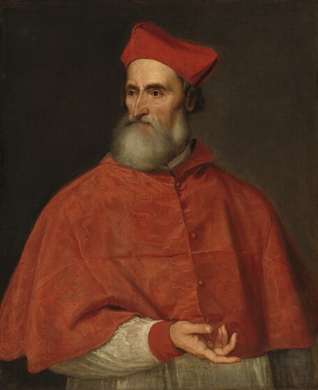 Shown from the waist up, an older, pale-skinned man wearing clerical robes gestures to our right with one hand and turns his head to look off to our left in this vertical portrait painting. His shoulders angle to our right, and that arm hangs by his side. His other arm is bent at the elbow, and the hand is held palm up so the fingers loosely point to our right. His gaunt face turns to our left, and he looks off with dark, deep-set eyes under heavy, curved brows. He has a high forehead, a long, thin, hooked nose, and hollow cheeks. His full, smoke-gray beard is painted with blended strokes so appears soft. His crimson-red hat comes to four rounded points over ear-length, dark gray hair. An elbow-length red cape has buttons down the front, and he wears a white garment with a red cuff around the hand we can see. The man is lit from our left in front of a brown background.