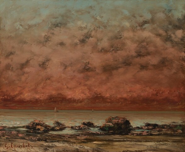 We stand on a beach lined with black rocks and boulders looking out onto the water below a brick-red sky that dominates this nearly square landscape painting. The sky along the top edge of the canvas is turquoise but it quickly fades to rich, salmon pink and then to deep red along the horizon, which comes only a quarter of the way up the composition. Steel-gray clouds ripple across the width of the painting. Two sailboats float in the water in the far distance. The water is painted the same turquoise of the sky with some reflections of the deep pink and red. Close to us, water breaks around the jagged black rocks beyond the a strip of mustard-yellow and tan sand that lines the lowest edge of the canvas. The artist signed the work in dark red paint in the lower left corner: “G. Courbet.”