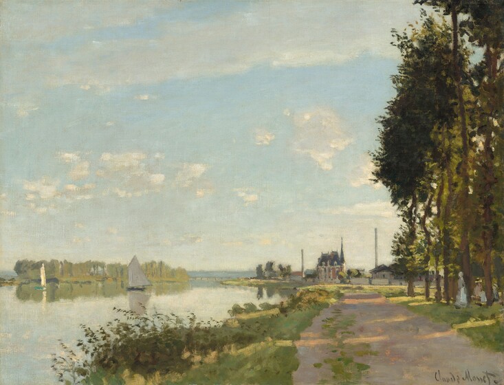 A sun-dappled dirt road runs away from us, parallel to a shimmering body of water under a blue sky dotted with white clouds in this horizontal landscape painting. The scene is loosely painted with visible brushstrokes, so some details are difficult to make out. The road moves back in space from the lower right corner of the canvas. It is lined with tall thin trees with narrow, dark green canopies to our right and with marshy grasses to our left. The road ends or curves in front of a row of terracotta-orange and gray buildings and smokestacks along the horizon, which comes about a third of the way up this composition. Two women and a child stand and sit in the shadows at the base of the trees to our right. Two sailboats drift on the glassy surface of the water. A row of celery-green trees on the horizon to our left and the sails of the boats reflect in the water. The artist signed the lower right corner, “Claude Monet.”