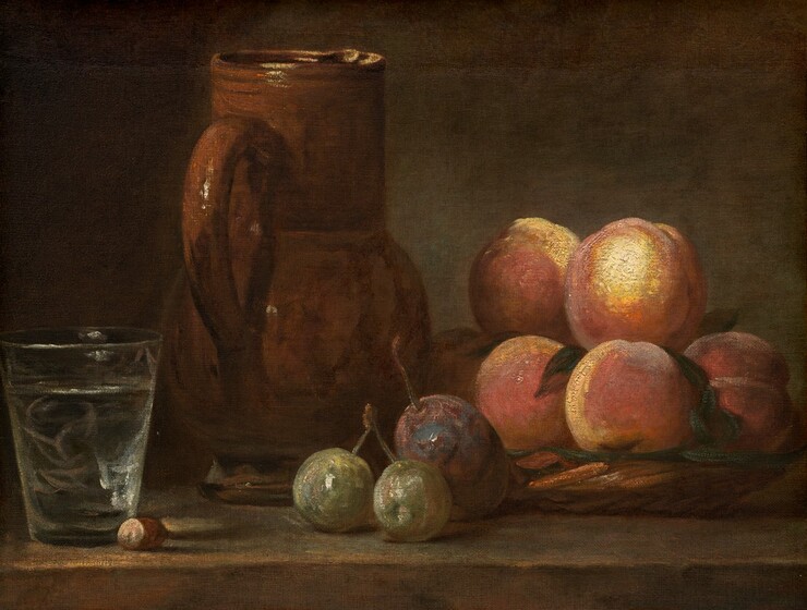 Light from the upper left falls across a glass, a pitcher, peaches in a basket, and other fruit arranged along a brown tabletop or ledge in this horizontal still life painting. The arrangement fills the height and width of the composition, and the table and most of the back wall are mottled with pecan brown and fern green. The background along the left edge of the composition is in deep shadow behind a translucent, wide-mouthed glass. Thin streaks of pale pink and white create reflections in the glass, and a brown hazelnut sits next to it. Moving right and a little farther back on the table, a tall, cinnamon-brown jug is turned so its handle faces us. A low, woven basket piled with at least six peaches sits next to the jug, filling most of the right half of the painting. The basket is lined with pine-green leaves, and the peaches have butter-yellow highlights. Three pieces of fruit sit on the table in front of the basket and jug: two small, frosty green, round pieces are connected by a shared stem and the larger, third piece of fruit is plum purple.