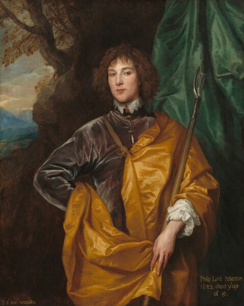 Shown from about the hips up, a young, pale-skinned man with curly brown hair stands facing and looking at us, wearing a plum-purple coat under a golden yellow cape in this vertical portrait painting. The man’s oval face is angled a little to our left so he looks out from the corners of his gray eyes. His left eyebrow, on our right, is slightly arched. His skin is smooth and his cheeks lightly flushed. He has a long, straight nose, his pink lips are closed, and there is a faintly painted suggestion of a goatee. Wavy bangs fall across his forehead, and he has curly, chin-length hair. He stands with his right hand, on our left, on his hip, and in his other arm, he holds a wooden staff with a pewter-gray, metal, scoop-like hook at the top. White lace trims the high neck of his garment and the cuffs of his sleeves. Light reflecting off the plum-purple coat suggests a soft material, possibly velvet. Crisp reflections on the deep, butter-yellow cape fastened over one shoulder suggest satin. An emerald-green cloth hanging from the top right corner of the painting falls behind the man’s shoulder. Behind the cloth and to our left, a craggy, rocky outcropping opens to a view of a landscape with a green valley and topaz-blue mountains in the distance. Bands of golden light illuminate the cloudy sky above. The work is inscribed with yellow lettering in the lower right corner to read, “Philip Lord Wharton 1632 about ye age of 19.” The artist’s name is painted in the lower left: “P. Sr Ant: vandike.”