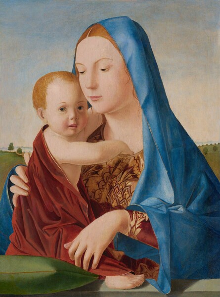 Shown from the waist up, a young woman embraces a baby in this vertical painting. They both have peachy skin, reddish-blond hair, and round faces. The woman is angled to our left and almost takes up the height of the painting. She looks down with gray eyes through lowered lids, under slender, arched brows. She has a straight nose and her pale pink lips are closed. Barely visible, a thin dotted white line spans her brow. A few loose, copper-colored tendrils frame her face under an azure-blue mantle that drapes over her head, shoulders, and arms. Under the mantle she wears a brick-red robe with a stylized, plant-like pattern in gold on the upper bodice and the cuff we can see. Her left elbow, on our right, rests on a sage-green ledge that runs along the bottom edge of the composition, and that hand dangles over the child’s leg. Her other hand curves around the baby’s back. The child is turned to our right to face the woman. He is wrapped in a cloak the same red as the woman's robe, and it has a thin gold border. He sits on a kelly-green cushion resting along the left side of the ledge. His head is turned to gaze off to our right with large hazel eyes under thin brows. He has a button nose and a rosy flush around his small pink mouth, which is slightly open. His right hand dips into the woman’s neckline while the other arm embraces her neck. His right leg stretches out toward her so one pudgy foot peeks out from under the red cloth. The horizon of the landscape behind them comes halfway up the painting. Sloping fields are dotted with trees. Low hills are ice blue in the hazy distance along the horizon, and the sky above is nearly white near the mountains, deepening to pale blue along the top edge.