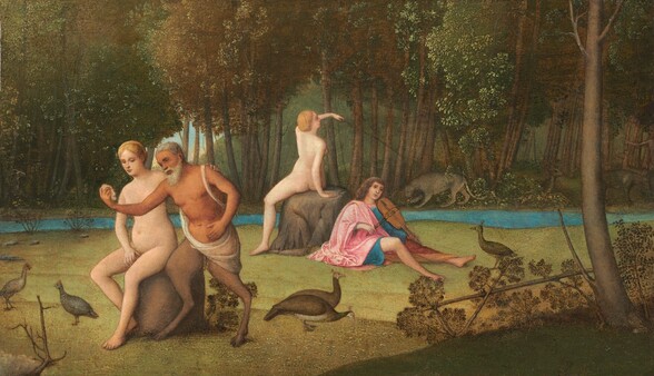 Two women, a man, and a satyr, a man with goat’s legs, are in two pairs in a forested landscape in this horizontal painting. The pale-skinned women are nude, and their blond hair is tied up and back. One woman sits on a brown boulder to the left of center. One hand covers her groin, and the other hand rests on the satyr’s shoulder. The satyr has deeply tanned skin, short white hair, and a long white beard. A white cloth wraps over one shoulder and across his hips. He holds up an object, perhaps a shell, with one hand. That arm crosses over the woman’s breasts. His other hand is by his lower belly, and he looks at the shell. A bit farther back and to our right, a second nude woman also sits on a boulder. She faces away from us and holds up a long stick with her left arm, which arcs over her body. A clean-shaven, pale-skinned man sits with his back against the boulder. He has long brown hair and looks off to the distance to our right. He wears a carnation-pink robe over a sapphire-blue tunic. His legs splay in front of him, his feet bare, as he holds a bow to a violin-like instrument tucked under his chin. The two pairs sit in a grassy glade occupied also by five pheasant- or peacock-like birds. A thin river running behind the glade is lined with spindly trees that together make an impenetrable bronze-brown and laurel-green canopy. The second woman’s stick points or is directed to a gray, mountain lion-like cat on the far bank. Closer inspection reveals deer and another person, who points, tucked among the trunks. A glimpse of blue sky is visible through a break in the tree trunks.