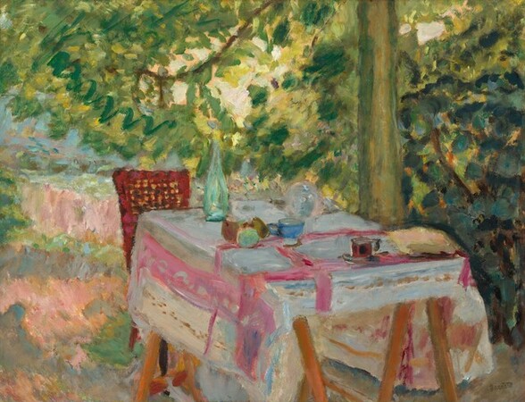 A chair and a table set with a bottle, fruit, and dishes sit on a grassy lawn under a tall tree in this horizontal painting. The scene is loosely painted with vibrantly colored, visible brushstrokes, creating the impression of dappled sunlight filtering through the tree’s canopy. Situated near the lower right corner, the table takes up most of the bottom half of the composition. Its wooden legs are cut off by the bottom edge of the painting. The tablecloth is cream white where it hangs off the sides, and turns ice blue in the shade, on the tabletop. Carnation-pink bands make a loose, plaid-like pattern. The table is set with a tall, sea-green bottle, round fruit in shades of amber brown and turquoise, and two teacups – one cobalt blue and the other cranberry red. Other loosely painted forms could be more dishes or foodstuff. One cane-backed, rust-red chair sits at the far end of the table. The lawn under and around the table is painted with strokes of pale pink, sky blue, and shamrock green. To our right, beyond the table, the sage-green tree trunk grows up and off the top edge of the painting. The upper half of the composition, from the bottom right corner to the top left, is filled with loosely painted, zigzagging strokes of moss, sage, lemon-lime, and pine-green strokes. The artist’s name appears in olive-green letters in the lower right corner, “Bonnard.”
