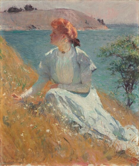 A pale-skinned woman wearing a long dress sits on a golden-brown grassy hillside in this vertical portrait painting. The scene is loosely painted with visible brushstrokes throughout. The hill creates a steep diagonal angling down from near the top left corner to the right edge, just over the lower corner there. The woman sits with her knees facing us as she looks up and off to our left in profile. She is lit from our right so her face is in shadow, but she has delicate features. The light warms her copper-red hair, which is tied with a bow at the back of her neck. Her ice-blue dress has a high collar, long sleeves, and a full skirt that puddles in the grass. She rests her left arm, to our right, across her midsection, and holds her other hand just over the grass. White flowers dot the hillside, which slopes down a single tree in the near distance along the right edge of the canvas. Ultramarine-blue water beyond ripples back to a flat-topped, smoky-mauve outcropping. A sliver of oyster-white sky lines the horizon, which comes almost to the top of this composition. The artist signed the painting in the lower left corner, “F.W. Benson.”