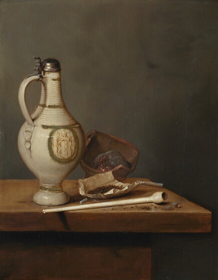 An ivory-white, lidded jug, a long, white clay pipe, an open paper packet of tobacco, and a burning ember in a clay pot are clustered together at the front corner of a wooden table in this vertical still life painting. Against a deep, sage-green background, the table extends off the left edge, and the front corner almost brushes the right edge of the composition. The objects are lit from our left, and the area beneath the tabletop is cast into deep shadow. To our left, the stoneware jug has a flaring foot, a round body, a handle next to its tall, ridged neck, and the narrow opening is covered with a metal cap. The jug has an olive-green band around the base and an oval of the same color on its body, enclosing a coat of arms. The crest has three, stacked Xes, and the date 1650 at the top. The cupped, metal lid is affixed to the top of the jug’s handle so it can be flipped up with a thumbpiece. The long, white pipe lies along the front edge of the table with its bowl tipped toward us. A knot of burning ash appears to have knocked out of the bowl. Behind the pipe is a folded, rumpled piece of paper holding nibs of dark brown, dried tobacco. More tobacco is scattered around the pipe, along with the ends of broken pipes, which resemble sticks of white chalk. A terracotta-brown dish holds a burning ember at the back of the table. The artist signed the work as if he had inscribed the front edge of the table with cursive letters, “Jan van de Velde fecit.”
