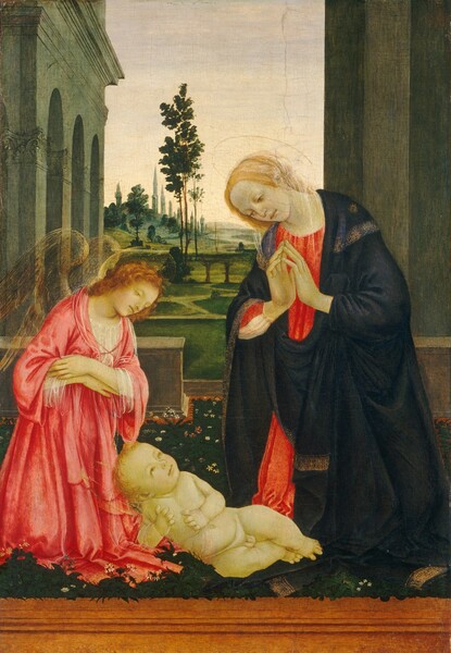 A winged angel, a woman, and a baby are gathered on a terrace that overlooks a softly lit landscape in this vertical painting. The people all have parchment-white skin tinged faintly with green, delicate gold halos, and they are close to us. The baby is round and plump, and faces us as he lies on his side on a carpet of pine-green grass dotted with small white and pink flowers. A band of caramel brown spans the lower edge of the painting. Propped up on one elbow, the baby turns his blond head to look at the woman kneeling beside him to our right. The woman, Mary, towers over the baby with her body angled slightly to our left. A midnight-blue cloak trimmed in gold is wrapped around her coral-red gown. The fingertips of her raised hands lightly touch as she bows her head and lowers her brown eyes to look at the child. A transparent white veil drapes over her blond hair. To our left, the angel also kneels and looks down at the baby with arms crossed over the chest. The angel has curly, copper-red hair and wears a carnation-pink robe over a transparent chemise. Semi-transparent, bronze-colored wings nearly disappear into the background. Just beyond the trio, a low balustrade with an opening near Mary encloses the space. A colonnade with arched openings extends into the distance to our left, behind the angel. A flat, olive-green wall rises the height of the painting behind Mary. Between them, the landscape is carpeted with moss and celery-green grass, and dotted with trees. A river winds toward slate-gray hills in the deep distance.