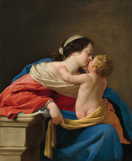 Shown from the knees up, a young woman sits nuzzling a baby in her lap in this vertical painting. They both have pale skin tinged with pink. The woman’s body is angled to our right with her head in profile. A narrow, white scarf ties around her dark brown hair, leaving soft tendrils brushing the side of her face and neck. Her eyes are lowered, and her pursed, rose-pink lips almost touch the infant’s upturned face. A sea-blue mantle is draped across her back and one shoulder, and wraps around to lie across her lap. Ivory-white fabric drapes across her neckline over a voluminous, coral-red robe. The nude, plump child faces away from us, perched on the woman’s knee. He turns to reach fir the woman, so we see a sliver of his flushed, left cheek and the tip of his nose. He has curly blond hair. One pudgy hand rests on her neck while the other cradles her chin. A mustard-yellow cloth wraps around his hips and under his dimpled bottom. The woman’s left hand, on our right, delicately embraces his hip. She leans onto her other arm, propped on a stone ledge to our left, and that hand loosely holds one end of the baby’s yellow drapery. The scene is lit from the upper left, and they are set against a background that transitions from earth brown on the left to cinnamon brown on the right. The artist signed the work as if he had written his name and the date on the face of the ledge, just under the woman’s elbow: “Simon Vovet Pinxit.1633.”
