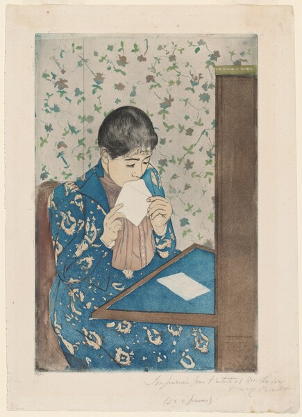 We look slightly down onto a young woman sitting at a writing desk as she licks an envelope in this vertical, color print. A table folds down or extends from a tall secretary desk to our right. The blotter on the table and the woman’s long dress are both cobalt blue. The dress has a vaguely floral pattern in white, and the jacket is open to reveal a vertically pleated, beige-pink shirt beneath. The woman’s skin is faintly tinted peach. Her black hair is pulled back over dark brows and a delicate nose. She holds the open flap of the envelope to her mouth with both hands. A piece of white paper lies on the desktop in front of her. She sits in a brown chair, and the wallpaper of the room is patterned with green and muted pink flowers against a white background. The sheet is inscribed with graphite across the right half of the bottom margin, “Imprimée par l’artiste et M. Leroy Mary Cassatt (25 épreuves).