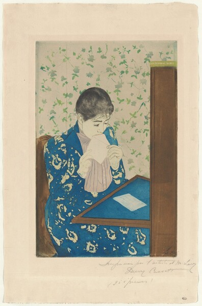 We look slightly down onto a young woman sitting at a writing desk as she licks an envelope in this vertical, color print. A table folds down or extends from a tall secretary desk to our right. The blotter on the table and the woman’s long dress are both royal blue. The dress has a vaguely floral pattern in the cream-white of the paper, and the jacket is open to reveal a vertically pleated, beige-pink shirt beneath. The woman’s skin is also the color of the paper. Her black hair is pulled back over dark brows and a delicate nose. She holds the open flap of the envelope to her mouth with both hands. A piece of white paper lies on the desktop in front of her. She sits in a brown chair, and the wallpaper of the room is patterned with green leaves against a white background. The sheet is inscribed with graphite across the right half of the bottom margin, “Imprimée par l’artiste et M. Leroy Mary Cassatt (25 épreuves).