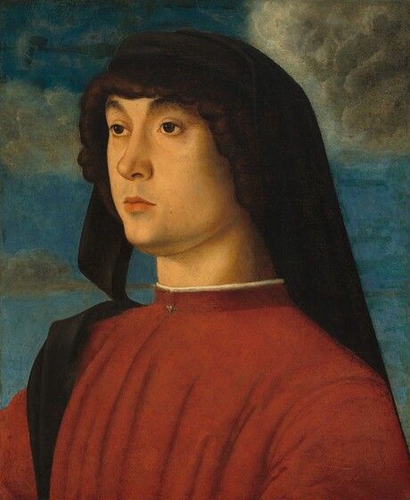Shown from the chest up, a clean-shaven young man with pale, peachy skin looks off to our left against a cloudy sky in this vertical portrait painting. His body is angled to our left, and he gazes in that direction with dark eyes under thick, arched brows. He has a long nose, smooth cheeks, and a hint of a five-o-clock shadow around his closed, peach-colored lips. Chestnut-brown hair is covered by a black headdress with two long tails. One end drapes over the front of his right shoulder, farther from us, and the other end hangs down his back. He wears a brick-red garment that falls in vertical pleats from a high collar. A white undergarment peeks out from the top of the neckline, and the collar is fastened with a small clasp at the throat. Behind him, tan-colored clouds float across a blue sky.