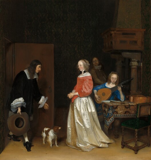 A man bows to a woman as another man looks on from the shadowy background, while a woman sitting at a table plays a lute in this vertical painting. All the people have pale skin. The bowing man enters from an open door to our left. He faces our right in profile and has a bumped nose, a dark mustache, and his brown hair falls loosely over his shoulders. He wears a voluminous, black jacket that has a wide white collar and flat, plate-like, starched white cuffs. He bends forward with one foot stretched in front of him, as he gazes at the woman to our right. His hands are spread wide. His left forefinger and thumb touch to make an O shape, and he holds a wide-brimmed, black hat in his right hand, closer to us. At the center of the composition, the woman wears a dress with a coral-pink bodice and a cream-white satin skirt trimmed with gold down the front and around the hem. She faces our left in profile and looks at the man, her cheeks flushed. Her eyebrows are slightly raised over dark eyes, and she has a straight nose and the hint of a double chin. Her blond hair is pulled back under a lace covering, and curls frame her face. A black ribbon is tied into a bow at the shoulder closer to us. A brown and white dog, about knee-high, stands between the man and woman. To our right, a young woman sits at the far side of a table playing a lute. She wears a sapphire-blue dress and looks down at her instrument. One elbow is propped on the patterned rug that covers the table. A second instrument, perhaps a cello, lies on the table, and a wooden chair with a pine-green upholstered seat has been pulled up to our side of the table. Almost lost in the shadows at the back of the room between the two women, a man with a goatee and wearing a brown jacket and trousers stands with his body angled to our right as he looks over his shoulder at the couple at the door. He stands in front of a fireplace with an opening so large that the mantle is supported by columns as tall as the man.