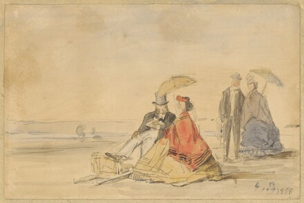 A Couple Seated And A Couple Walking On The Beach